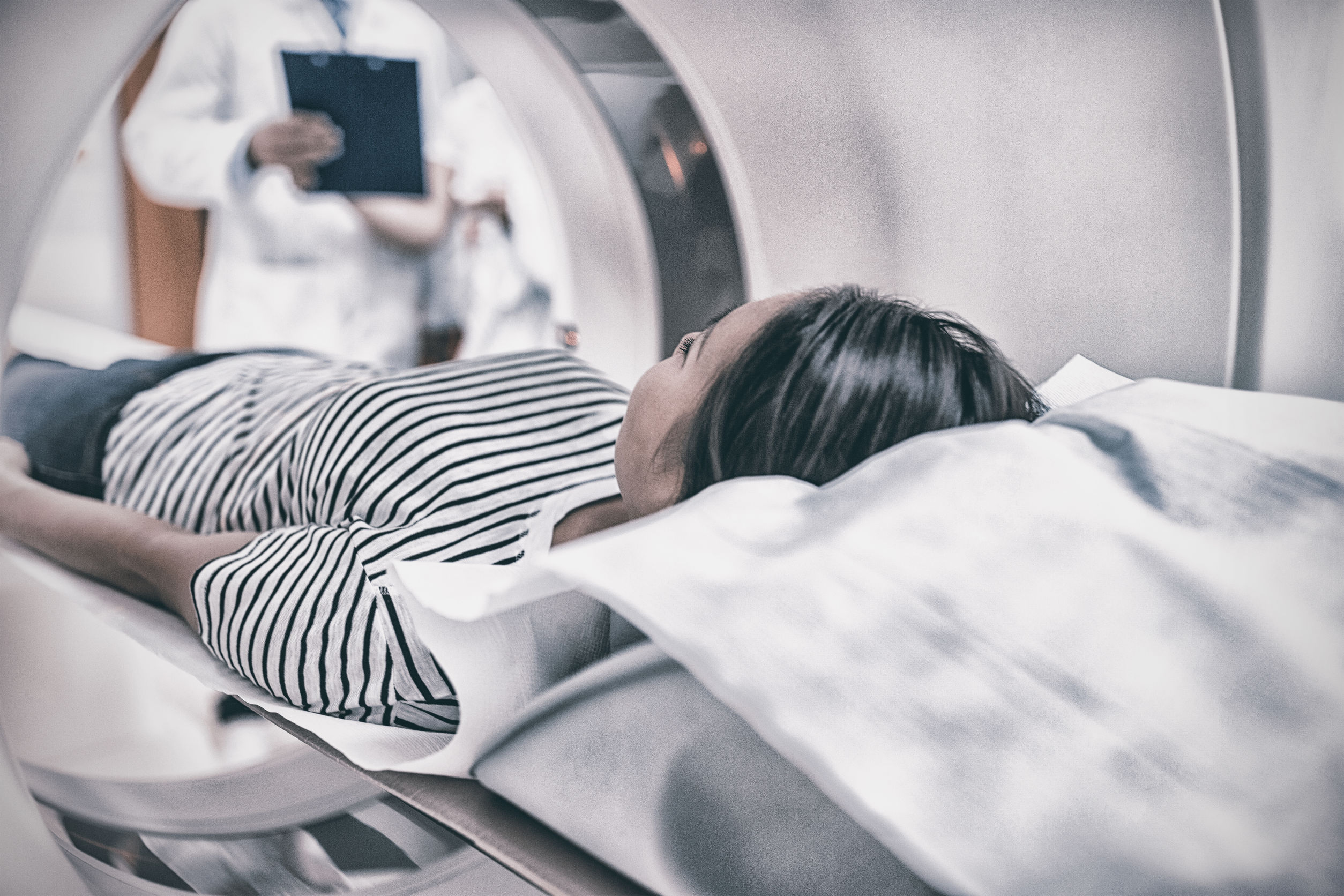 Female patient undergoing CT scan in hospital